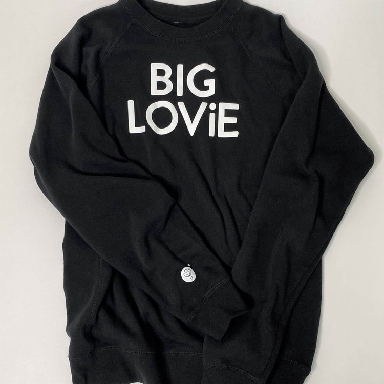 BIG LOViE CREWNECK SWEATSHIRT BLACK displayed on a gray background, highlighting its bold lettering and relaxed fit.