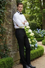 Model wearing Washington Black Stretch Blend Tuxedo Pants in a garden setting, exuding elegance and sophistication.